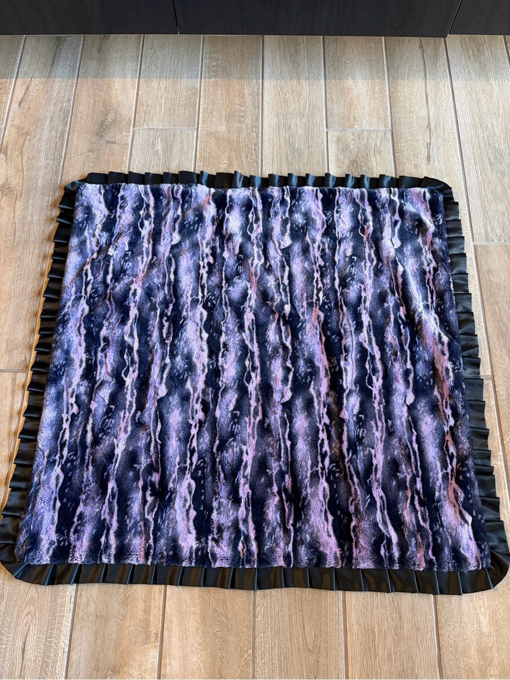 plush purple and black textured faux fur minky blanket with a ruffled border